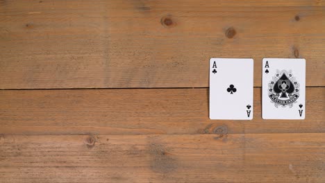 A-person-laying-out-a-quads-or-four-of-a-kind-on-a-wooden-table-to-educate-the-viewer-on-how-to-play-poker