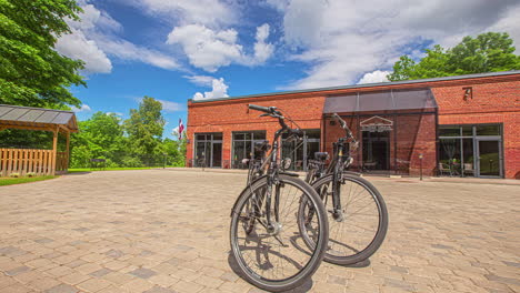 two vintage bicycles outside a brick storefront on a sunny summer day - dynamic parallax motion time lapse