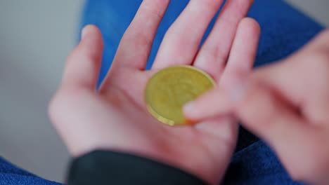 handling of gold btc coin reflects curiosity in cryptocurrency trend, young boy
