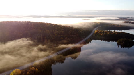 Morning-fog-with-sun-rays-between-mountains-and-lakes-in-La-Verendrye-Wildlife-Reserve