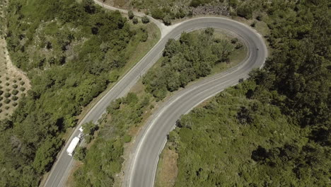 Truck-And-Bike-In-Opposite-Direction-On-The-Route-In-Reguengo-Do-Fetal,-Batalha,-Portugal-Passing-By-On-The-Road-Curve---aerial-drone