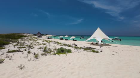 white beach tents and umbrellas on sand beach tropical paradise, ocean background