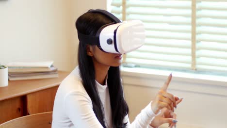 Woman-using-virtual-reality-headset-in-living-room