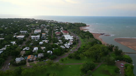 Aerial-Drone-of-Rapid-Creek-Casuarina-Drive-Traffic-Along-Beachfront-Bend-By-Coastline,-Pullback