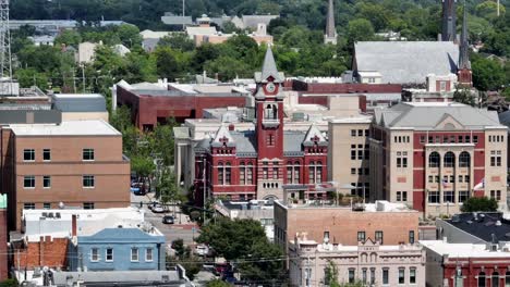 Elevate-your-project-with-this-mesmerizing-aerial-view-of-a-charming-town,-with-special-emphasis-on-its-iconic-clock-tower