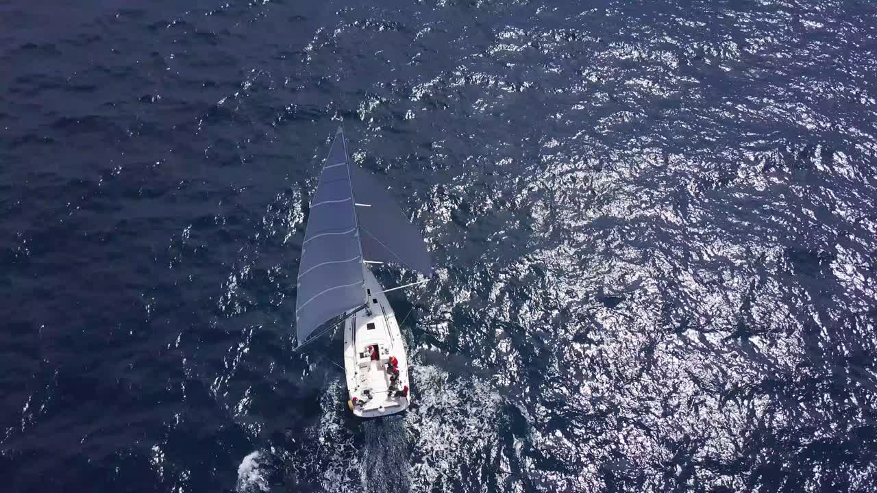 Sailboat sailing on the Blue Sea - Aerial Drone top down View