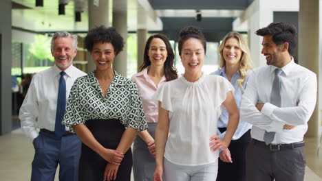 portrait of smiling multi-cultural business team inside modern office lobby