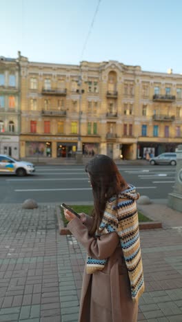 woman using phone in city street