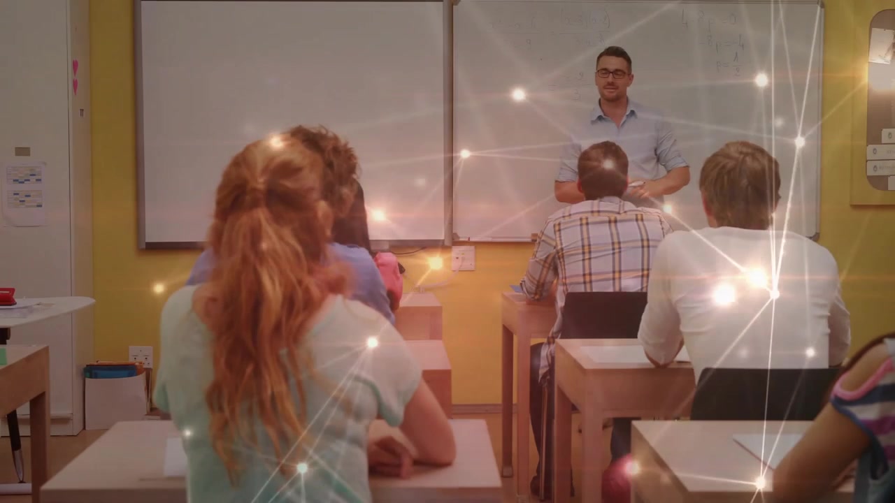 Teacher holding marker to whiteboard teaching math class with pulsing digital overlay around desks