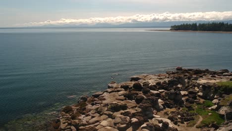 drone-shot-of-tribune-bay-rock-formations-with-eagle-fly-by