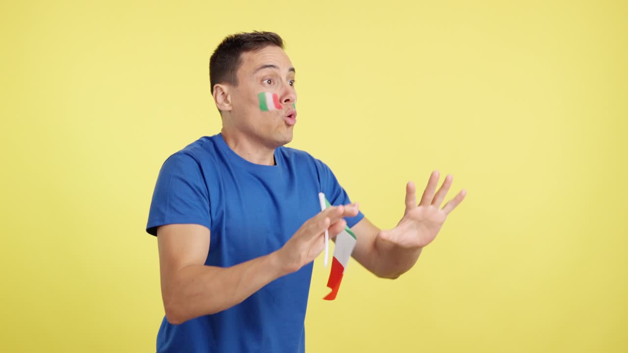 Italian supporter screaming and waving a national flag looking away