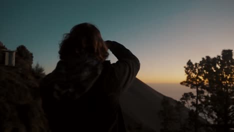 Traveler-Taking-Photos-Of-Fuego-Volcano-In-Silhouette-At-Dusk,-Viewed-From-Acatenango-Volcano-In-Antigua,-Guatemala