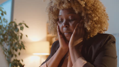 stressed african american businesswoman overworking in office