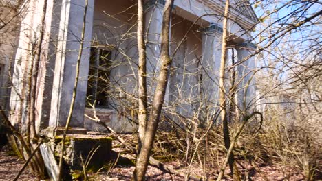 grand neglected soviet political building behind trees, chernobyl