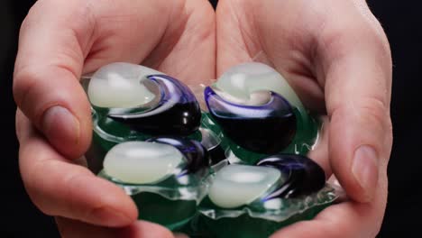 laundry pods in hands
