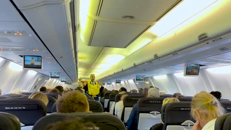 flight attendants demonstrate safety procedures to passengers