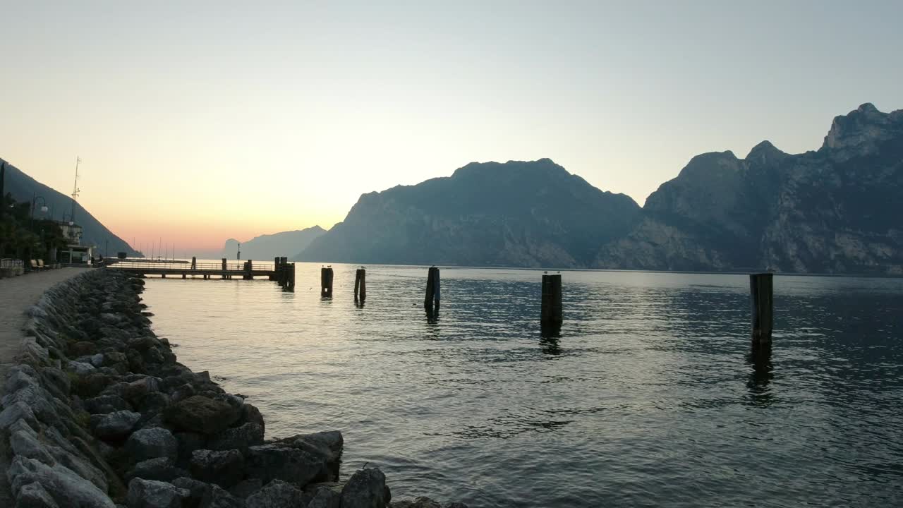 Landscape view from the shore of Torbole, Garda Lake, Italy. Panning camera shot