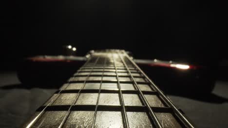 close up of electric guitar strings in a dark studio with cinematic lighting