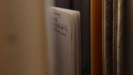 close-up of a notebook and stacked papers
