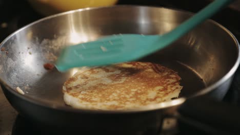 Turning-Both-Sides-Of-A-Pancake-Using-A-Plastic-Turner---Close-Up-Shot