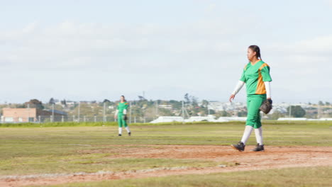 multiracial female baseball players playing baseball, throwing the ball and running on a pitch