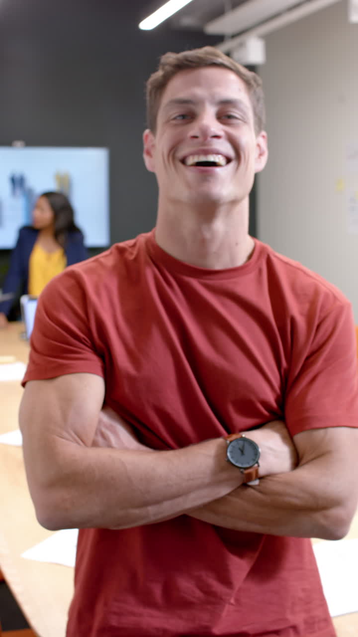 Vertical video of portrait of happy caucasian businessman in office in slow motion