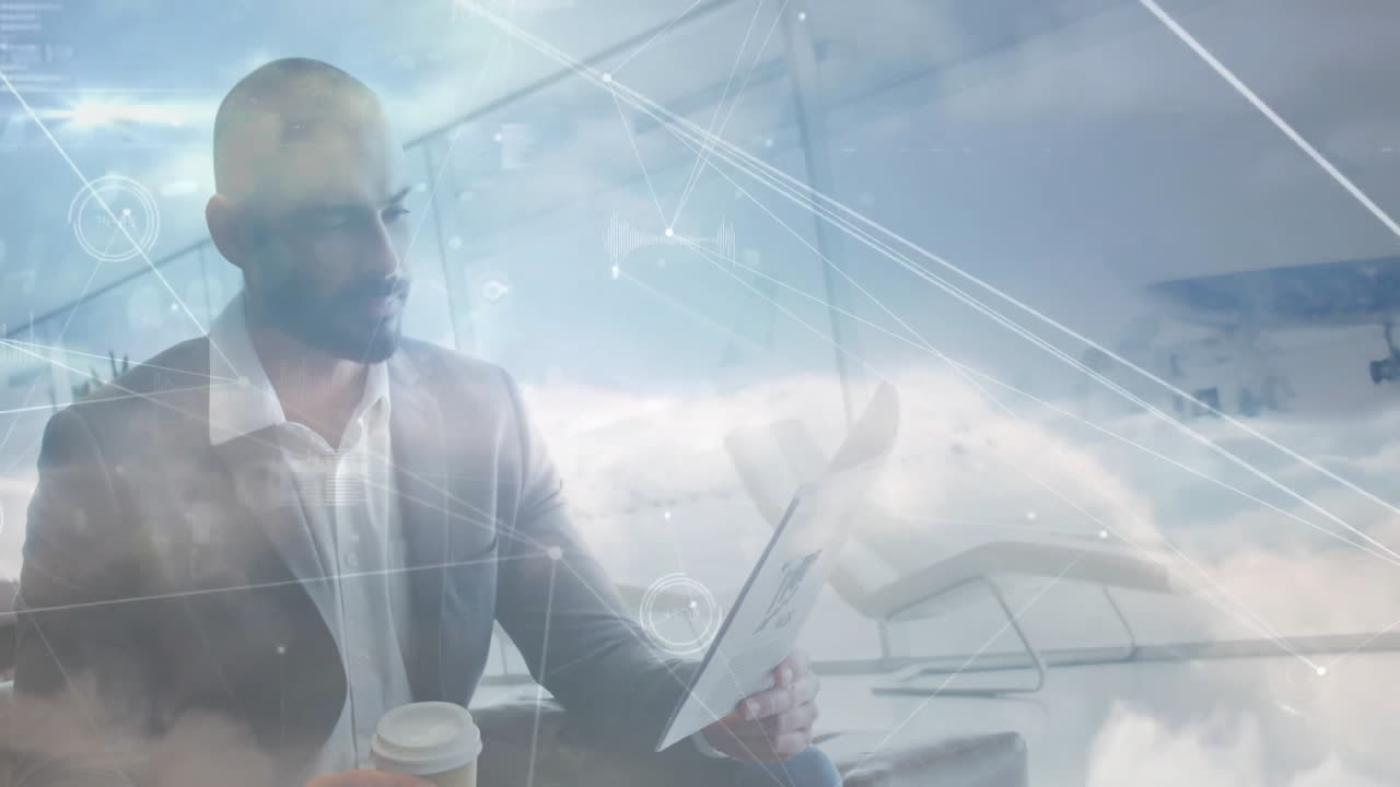 Holding tablet and coffee, businessman viewing network connections animation in office