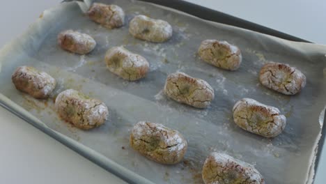 freshly baked chewy pistachio amaretti christmas cookies on a baking sheet