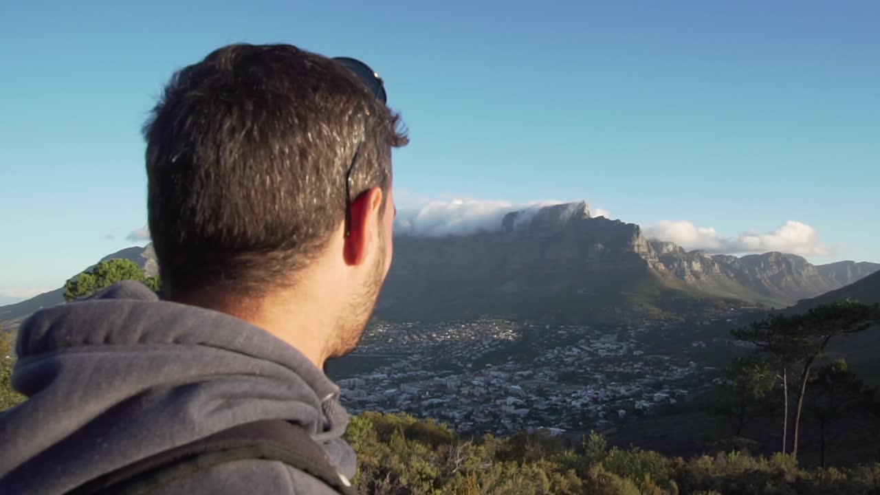 Man looking at city of Cape Town, Table Mountain and Lions Head in Slow Motion