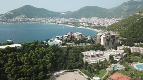 Bečići-town-in-the-municipality-of-Budva,-Montenegro-drone-reveal-luxury-resort-with-scenic-landscape-on-Adriatic-Sea