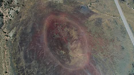 Aerial-video-flying-over-the-Santa-Clara-volcano-crater-in-Snow-Canyon-State-Park,-Utah