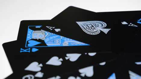 Close-up-shot-of-black-cards,-an-az-of-spades-and-a-king-of-hearts