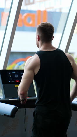 man training legs in sport club. young athletic man running on treadmill in sport gym