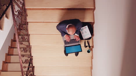 top view of businessman looking at screen analysing pie charts