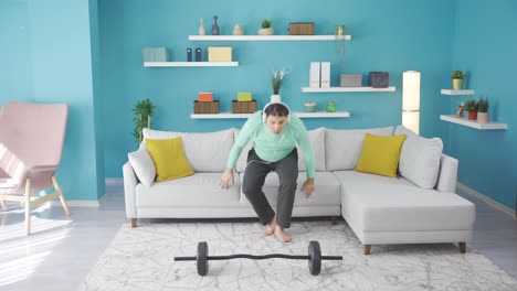funny and overweight man can't lift the weight off the ground.