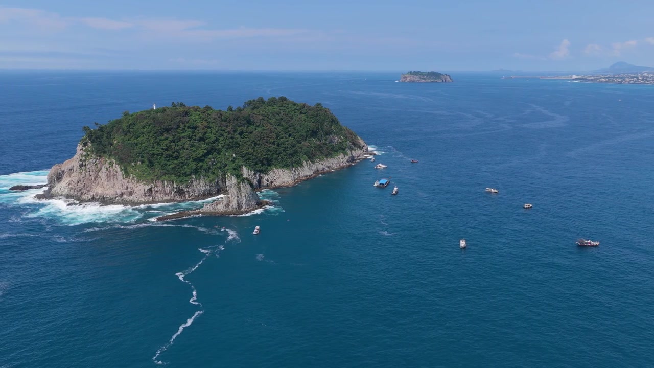 Boats Floating Around Munseom Island In Seogwipo-si, Jeju Island, South Korea. - aerial shot
