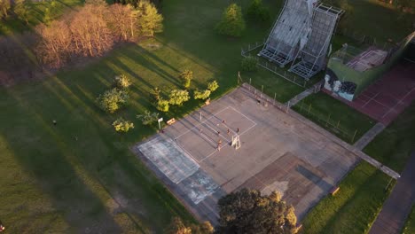 Amateurs-playing-volleyball-in-park-at-sunset