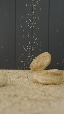 Seasoning-bagels-with-sesame-seeds-dropping