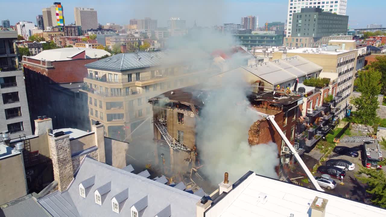 Montréal Hostel Fire: Fire Crews Spraying Water from Truck Ladders, Aerial Video
