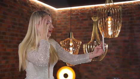 stylish woman taking a selfie with chic and attractive lighting that enhances her look a stylish and fashionable woman takes a selfie illuminated by exquisite and elegant lighting fixtures around her