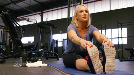 Senior-woman-stretching-in-fitness-studio-4k