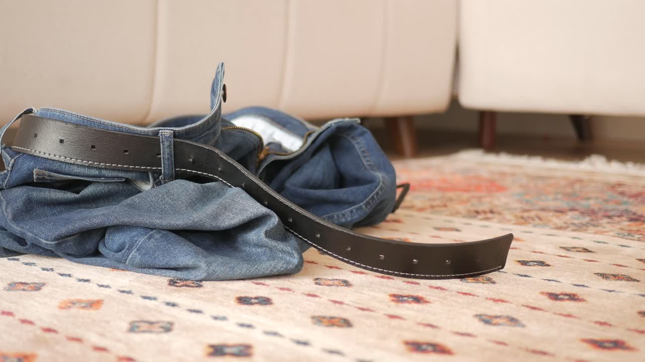 Jeans and Belt on a Carpet