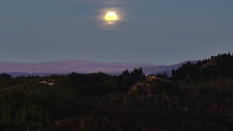 Aerial-View-The-Moon-At-Night-Over-San-Carlos-de-Bariloche-In-Argentina-Beside-Nahuel-Huapi-Lake
