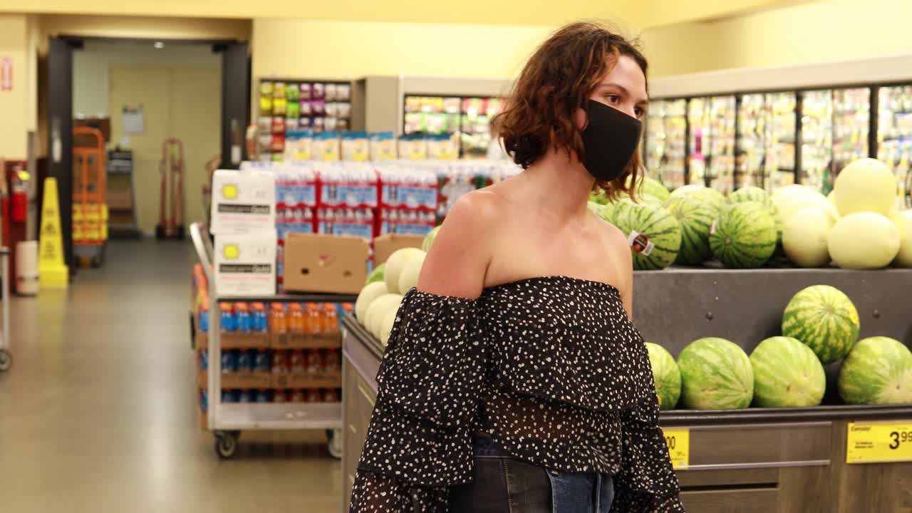 covid19 코로나 바이러스 전염병 동안 슈퍼마켓 농산물 섹션의 마스크 상점에 있는 여성