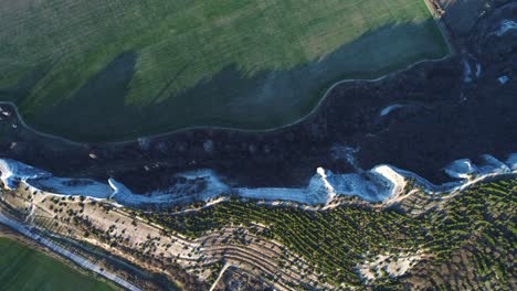 aerial view of a valley with cliffs and farmland