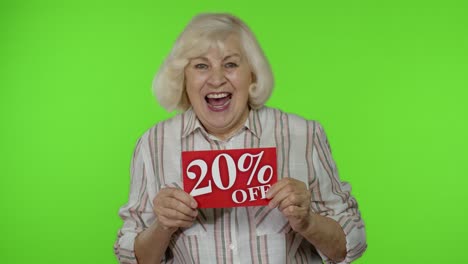 Smiling-grandmother-showing-20-percent-Off-inscription-signs,-rejoicing-good-discounts,-low-prices