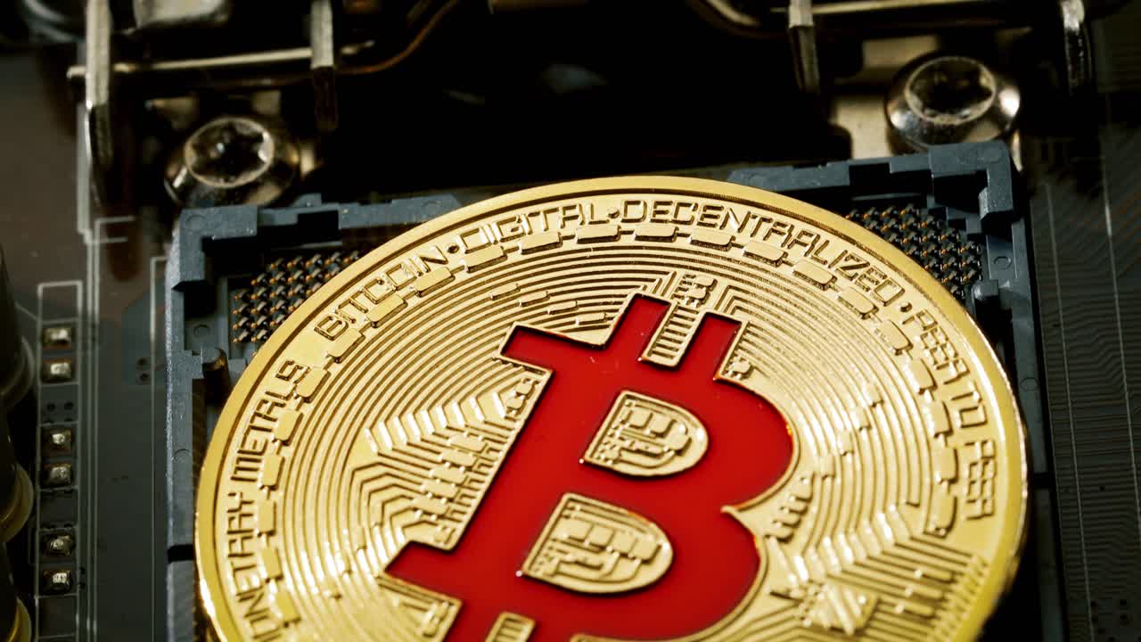 Gold Bit Coin BTC coins on the motherboard. Bitcoin is a worldwide cryptocurrency and digital payment system called the first decentralized digital currency.