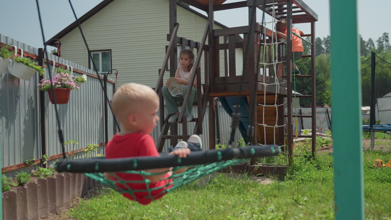 Children Playing Outside, Kids Enjoying Backyard Summer Activities, Siblings Exploring Garden Toys And Outdoor Play, Children In Backyard Spending Sunny Day On Playset And Swinging Ropes