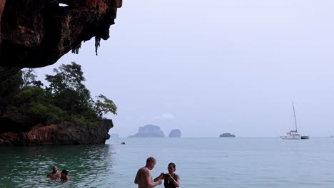 tropical beach scene with people and boats