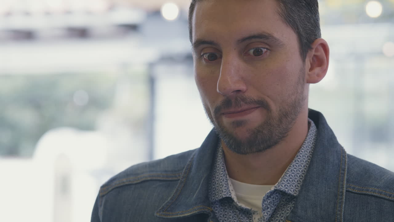 Medium shot of a man receiving a sample of ice cream at an ice cream parlor. His face conveys emotion and fond memories, evoking moments from the past.
